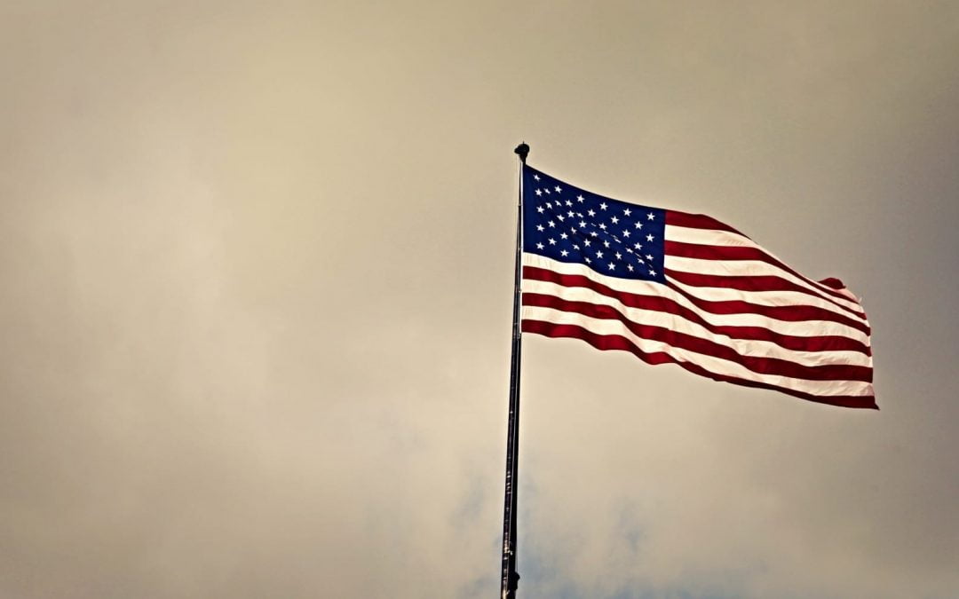 A U.S. flag flying on a cloudy day