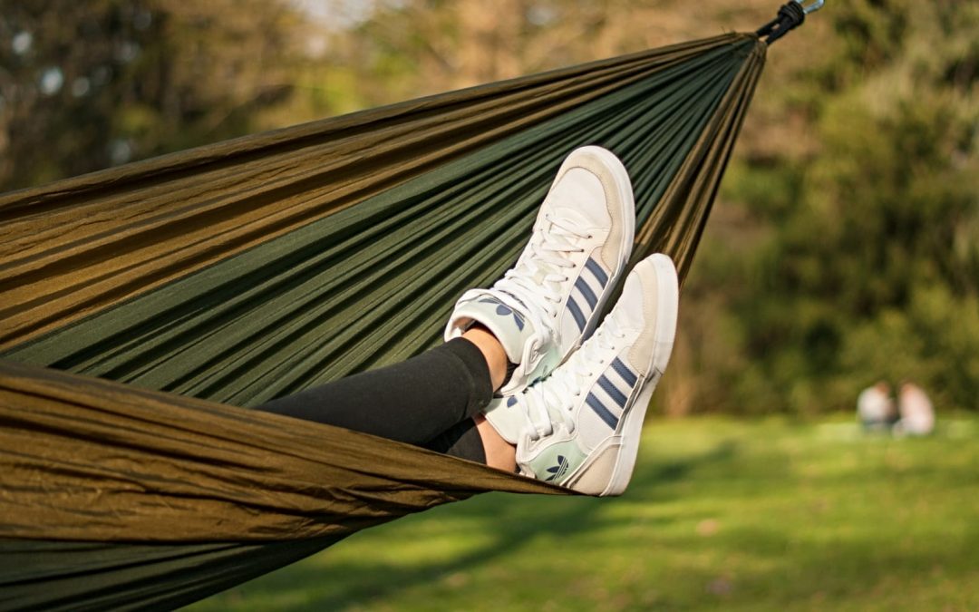 A person lying in a hammock