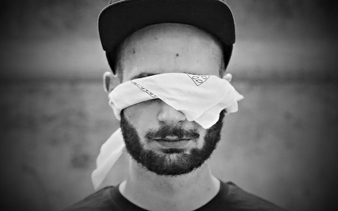 A man wearing a blindfold