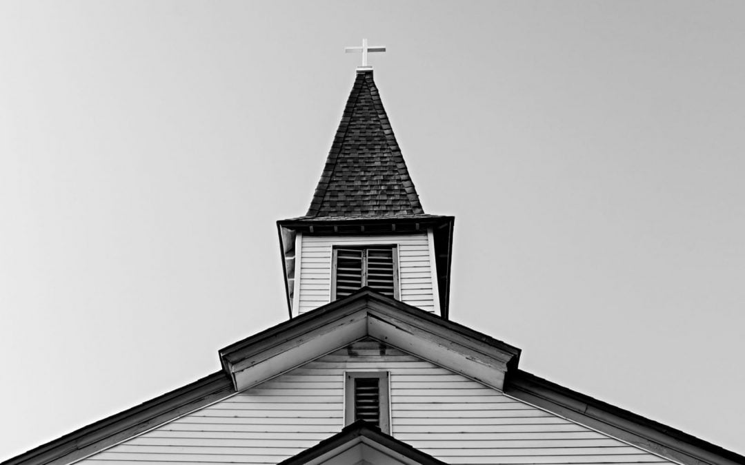 A white church set against a gray sky