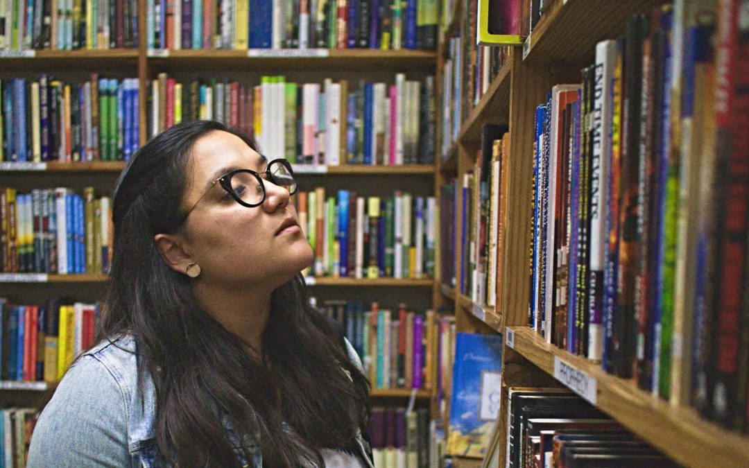 Women wearing glasses looking at library books