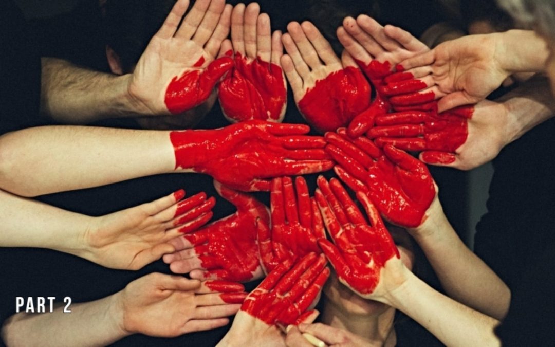 A group of hands with red heart painted on them