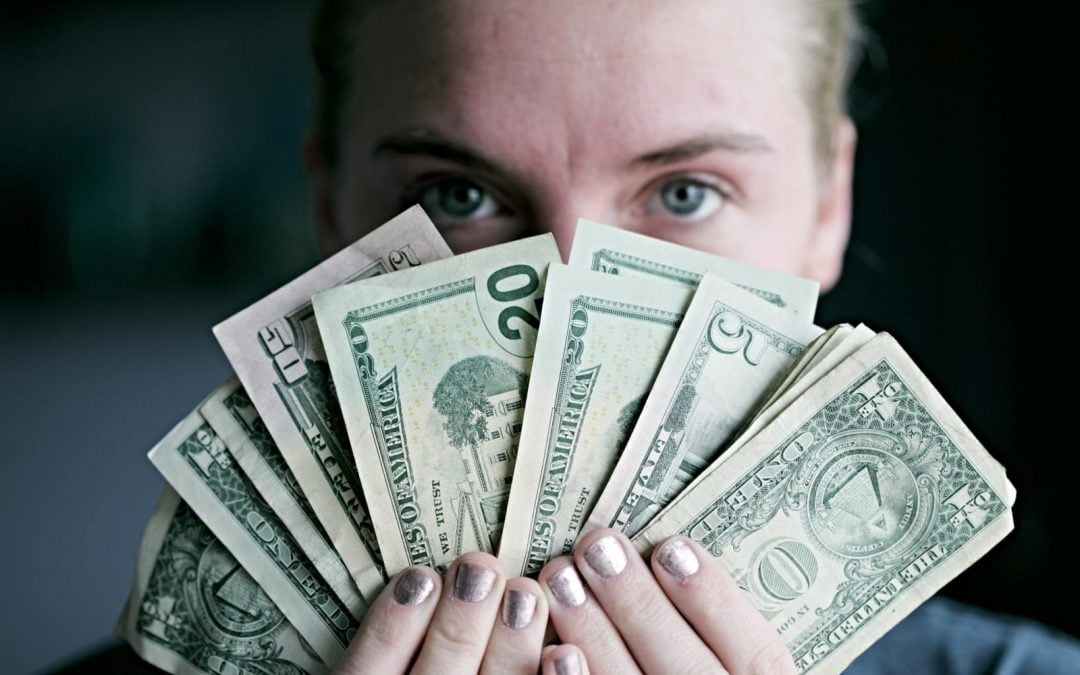 Woman fanning bills of cash