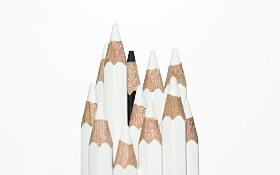 White pencils with one black pencil