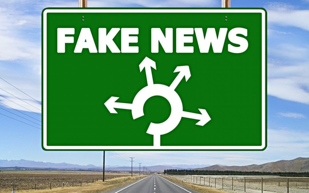 Fake-news sign with multiple directional arrows over highway