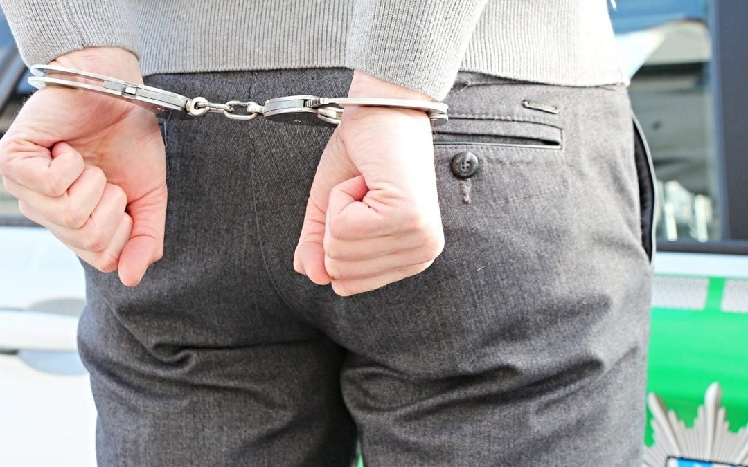 Back of man wearing handcuffs