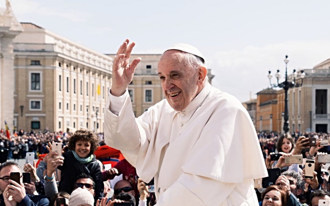 Pope Francis waving in crowd outside
