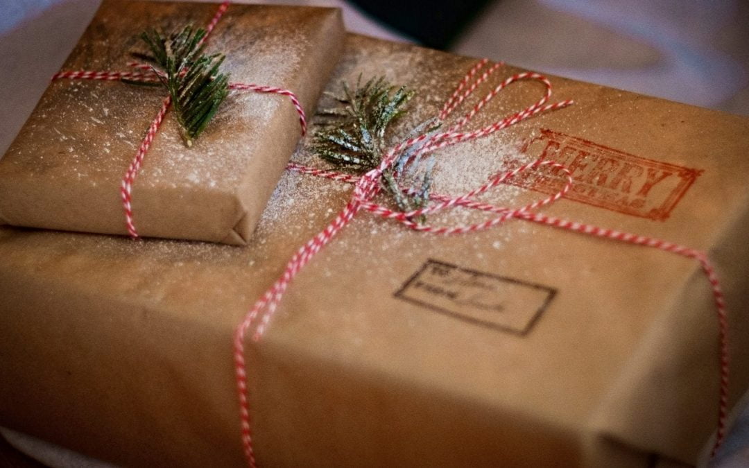 Brown paper-wrapped gift with Christmas decorations