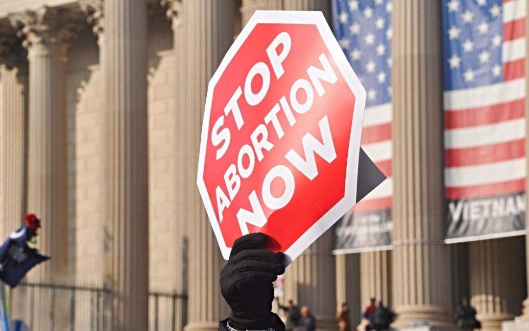Protest sign shaped like stop sign and opposing abortion
