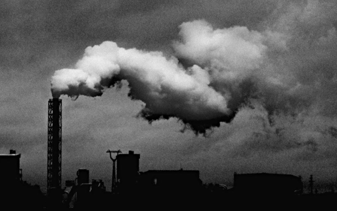 Pollution spewing from factory smokestack