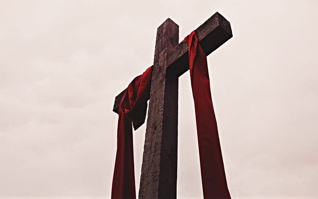 Cross with garment draped across beam