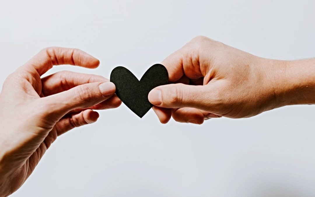 Hands holding a paper heart