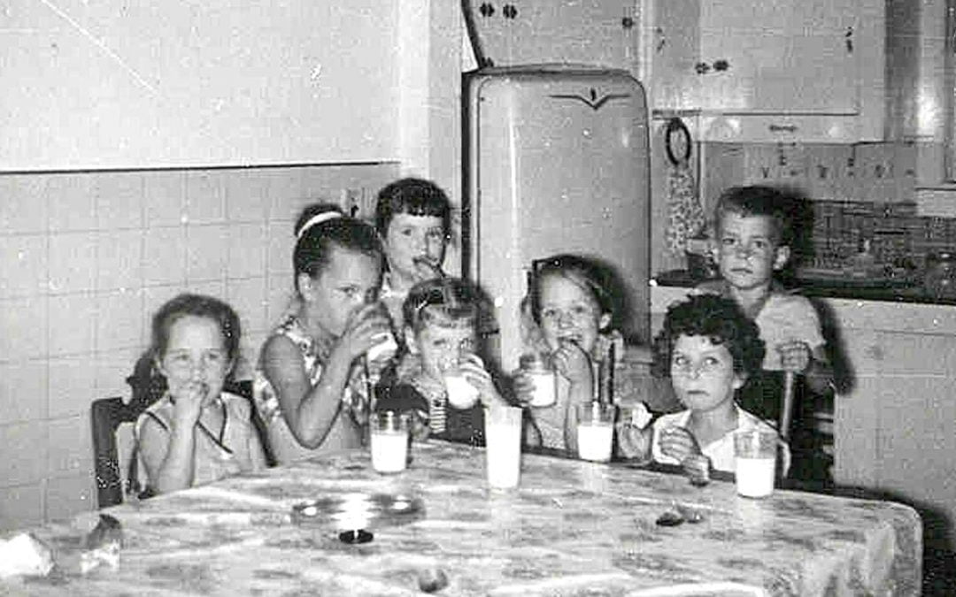Seven children around kitchen table