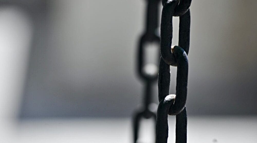 Links of chain with a gray background