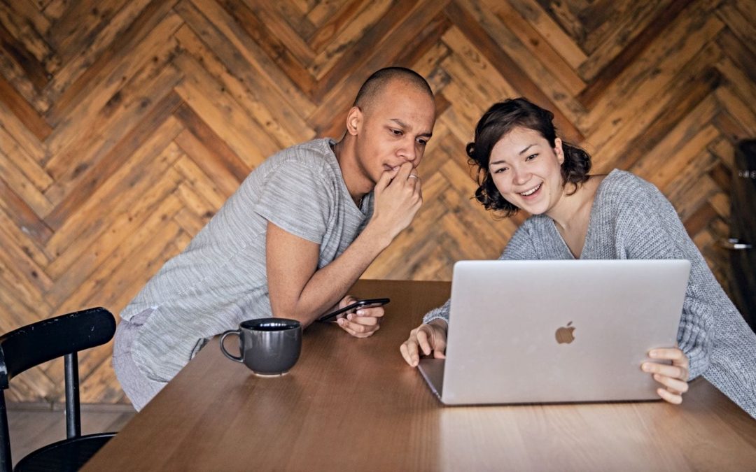 Man and woman watching laptop