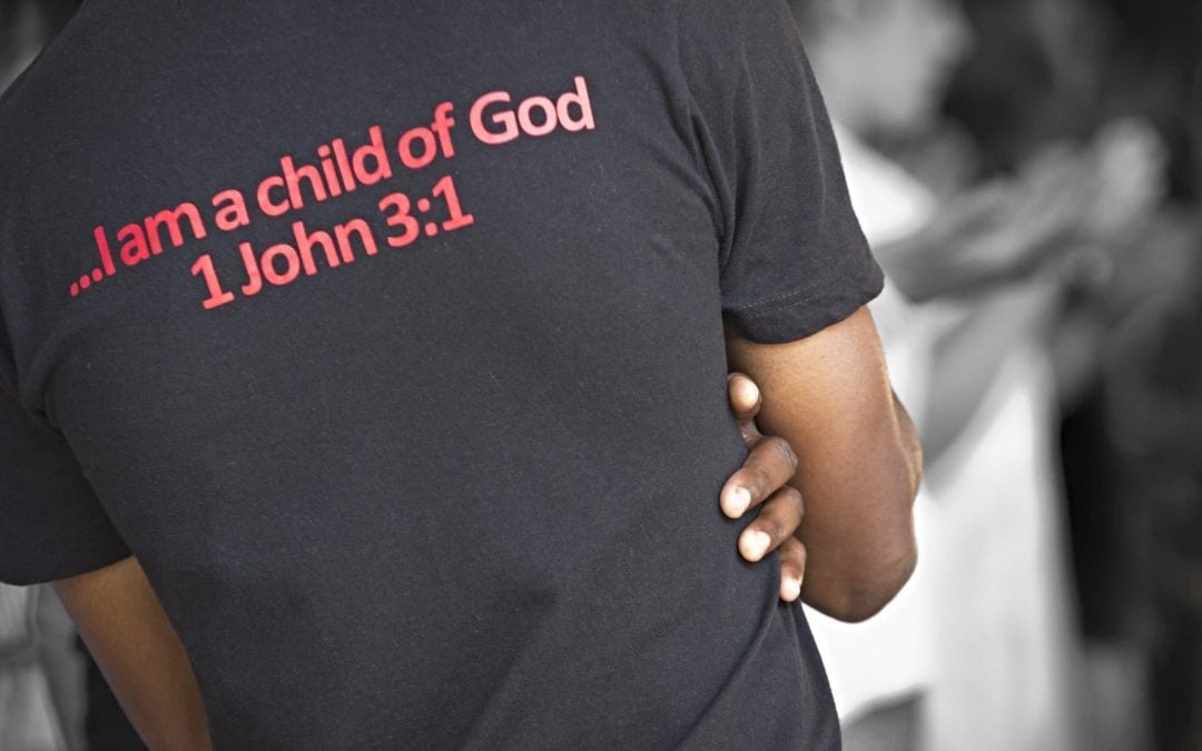 Black man wearing T-shirt with Bible verses