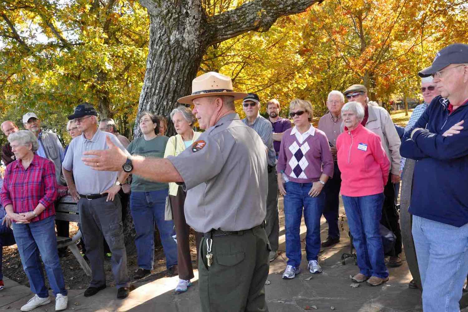 A group of people listening to a park ranger