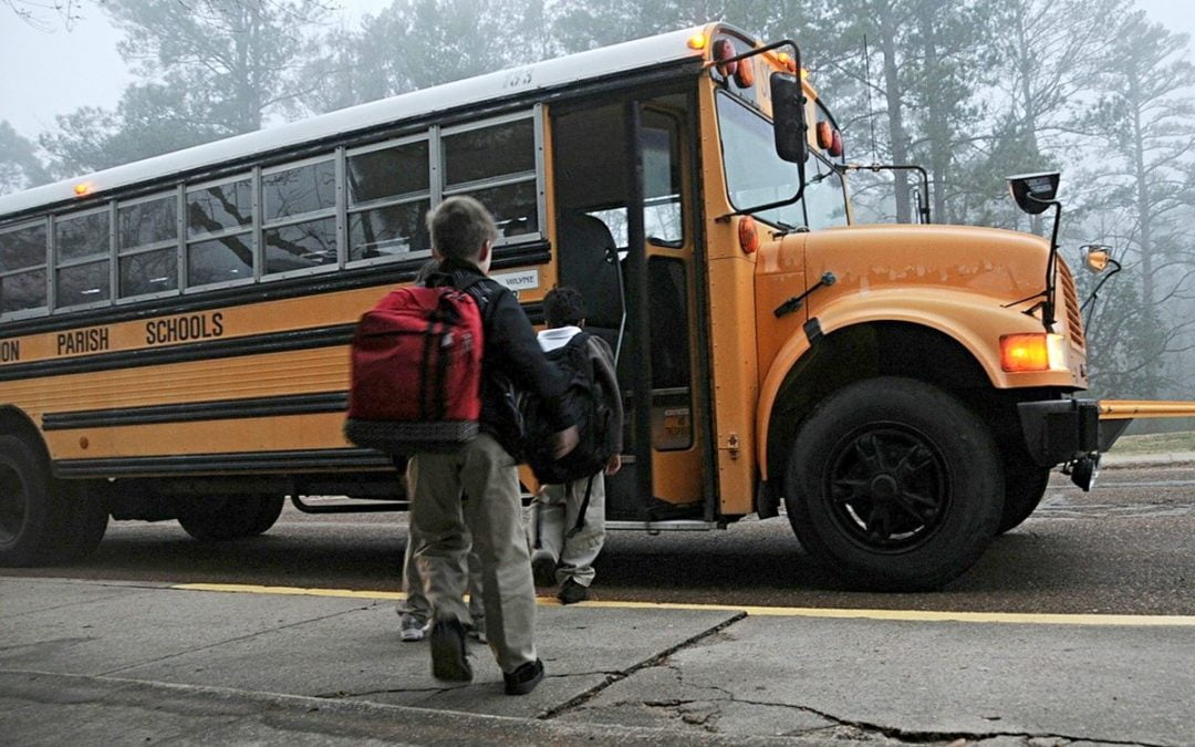 Child in line to board school bus