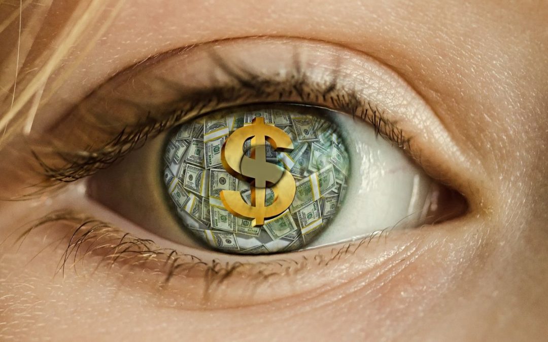 Dollar sign and dollar bills reflected in person’s eye