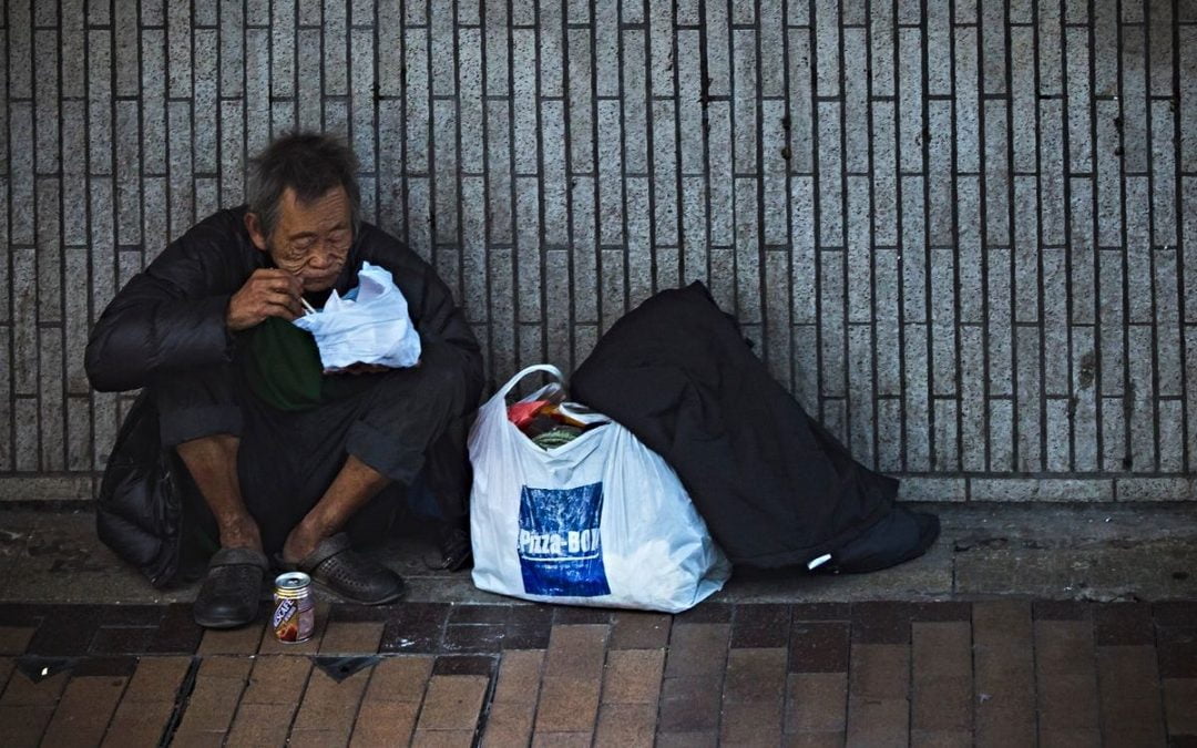 Man eating meal on sidewalk