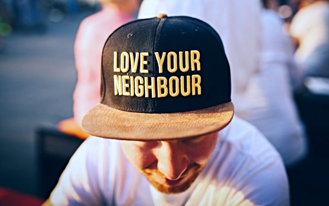 Man wearing cap with words Love Your Neighbour
