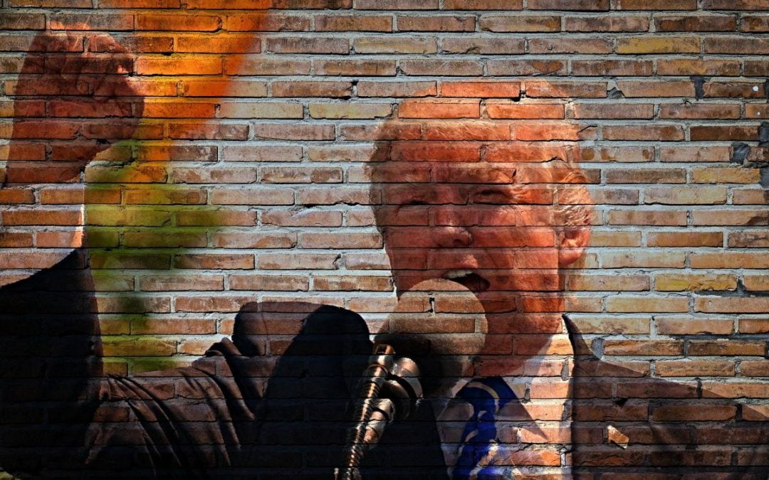 President Trump photo superimposed on brick wall