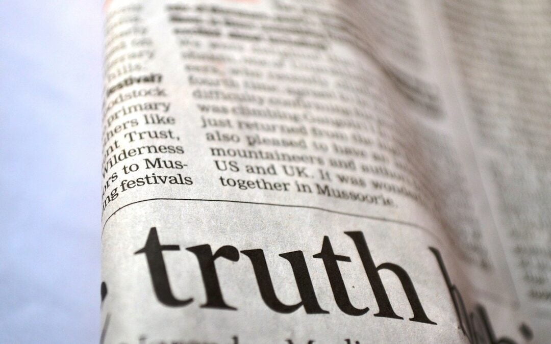 A folded newspaper with a large headline that begins with the word “truth.”