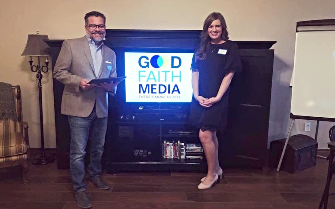 A man and a woman standing in front of a TV screen with the Good Faith Media logo displayed