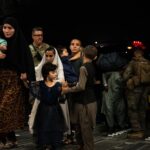 An Afghan family boarding a U.S. military plane.