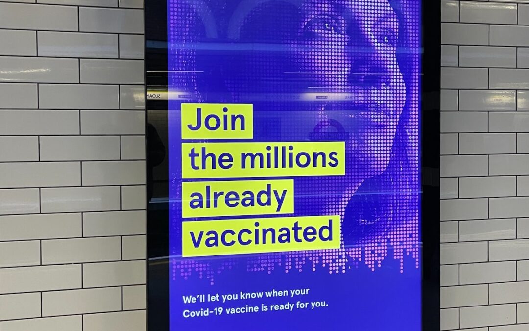 A sign in a subway terminal that says, “Join the millions already vaccinated.”