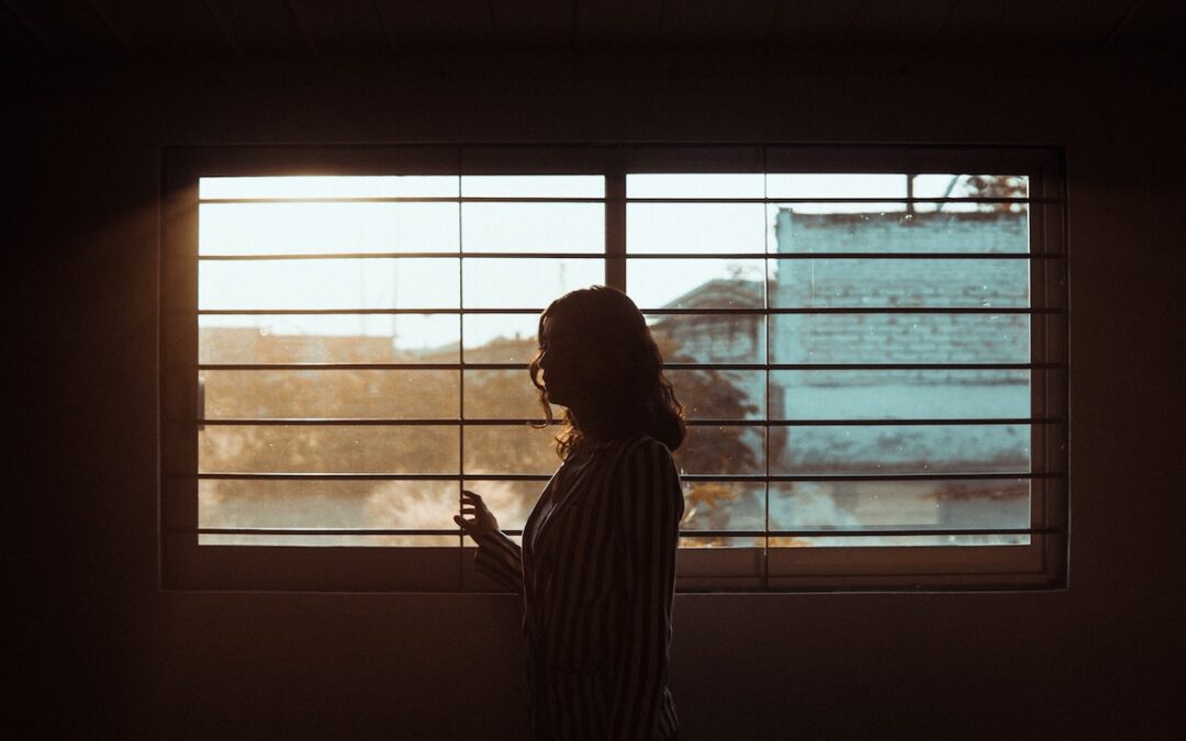 A woman’s silhouette in front of a window.