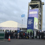 People in a line outside waiting to enter the COP26 meeting in Glasgow.