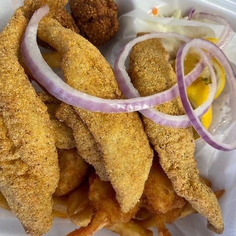 A plate of fried catfish with sides.