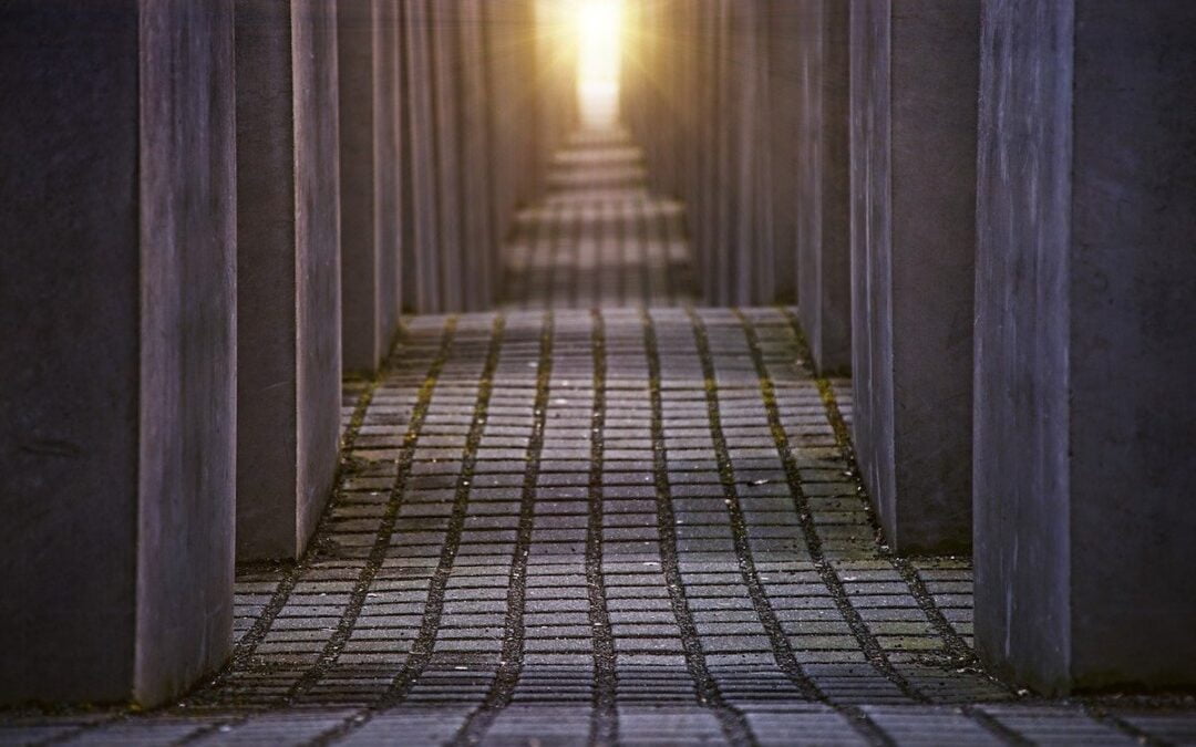 A pathway between concrete blocks within a Holocaust memorial in Berlin.