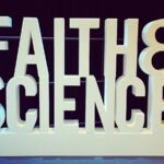 A 3D word display of large white letters with the words “Faith & Science” stacked on top of each other.