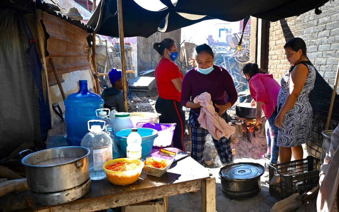 Migrant women prepare food in a protective shelter in Nuevo Laredo.
