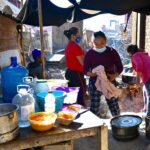 Migrant women prepare food in a protective shelter in Nuevo Laredo.