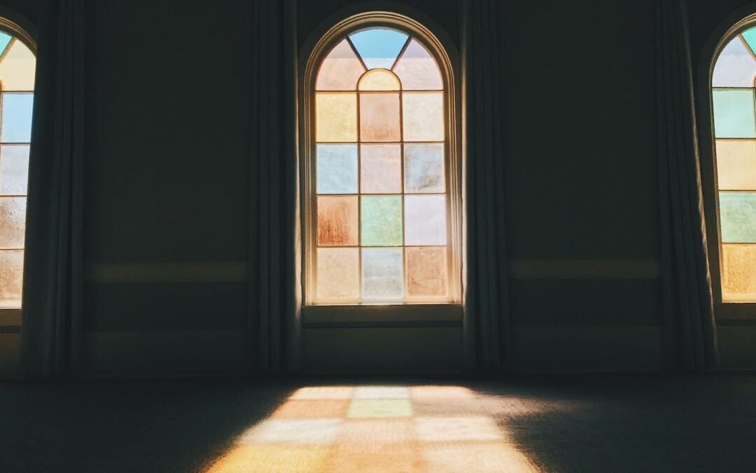A stained glass window with sunlight shining through it.