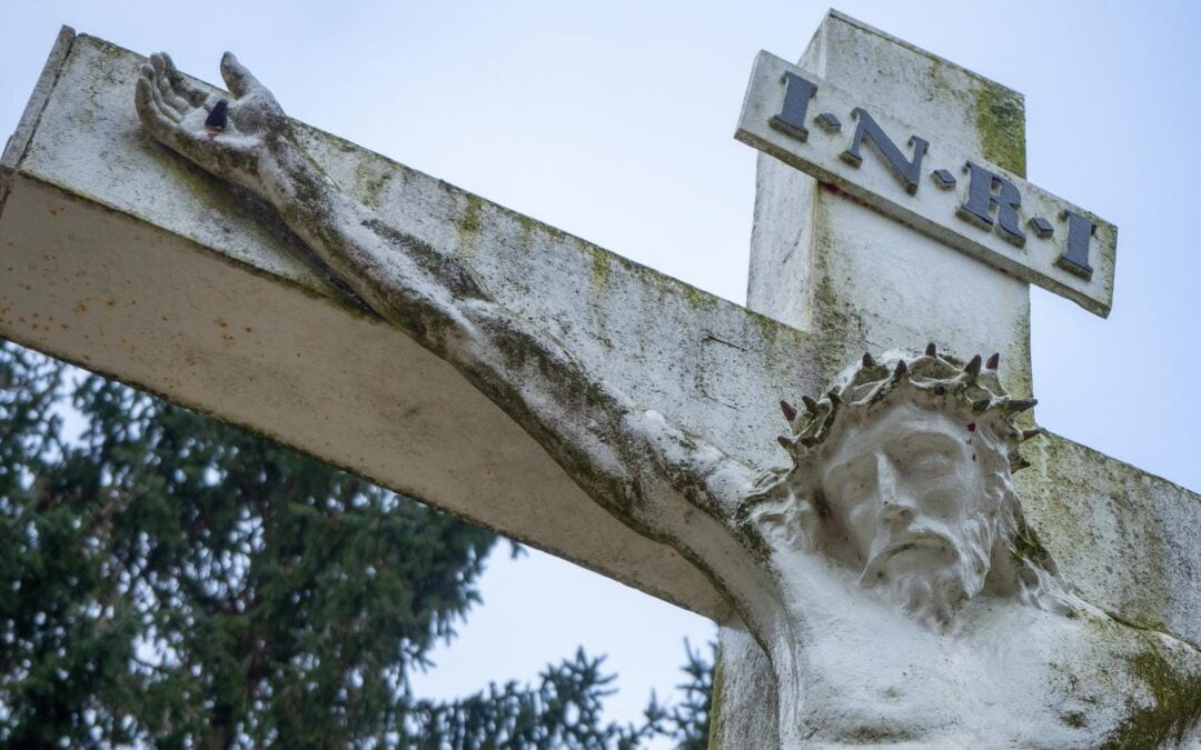 A concrete statue of Jesus on the cross.