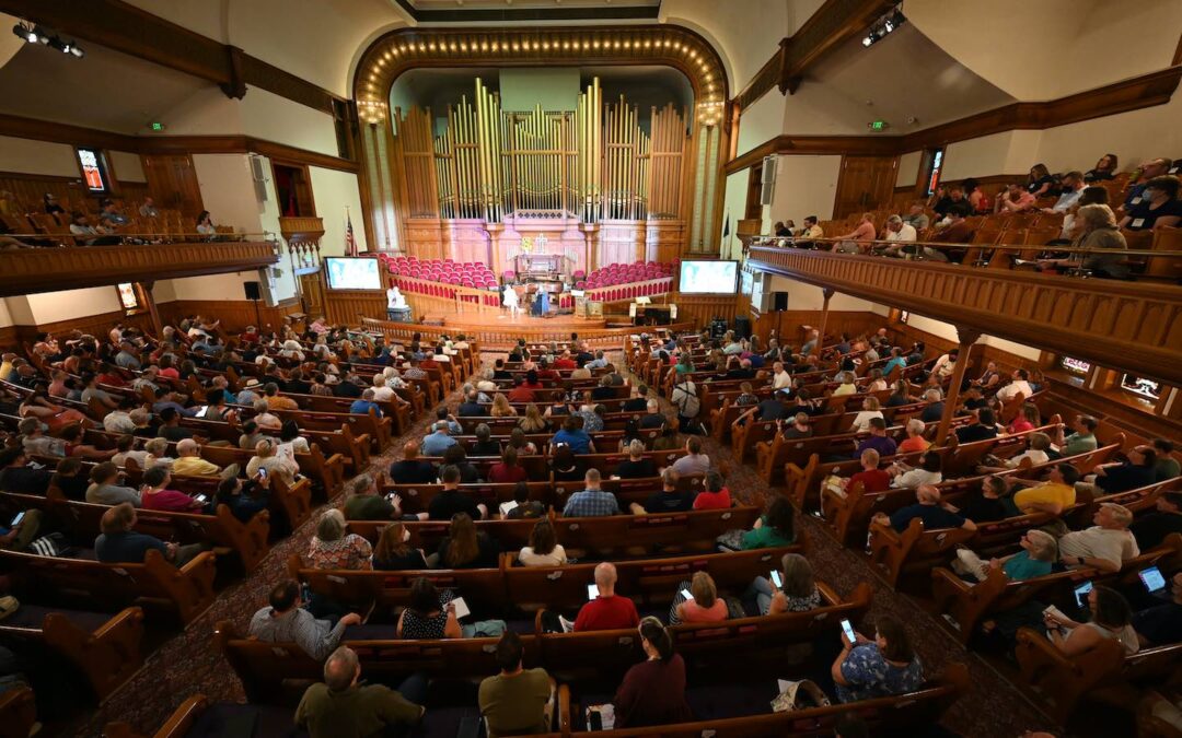 A church sanctuary filled with people seen from above in the upper balcony.