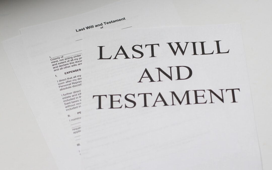 A table with several documents related to a last will and testament sitting on it.