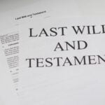A table with several documents related to a last will and testament sitting on it.