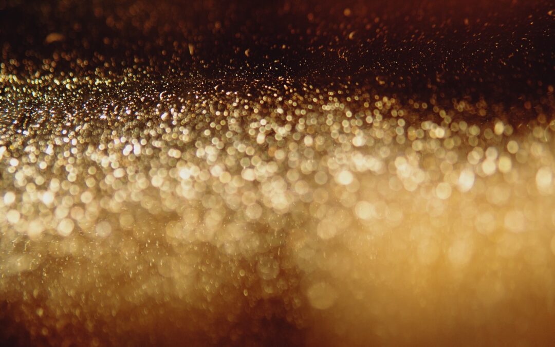 An abstract image of golden and yellow particles.