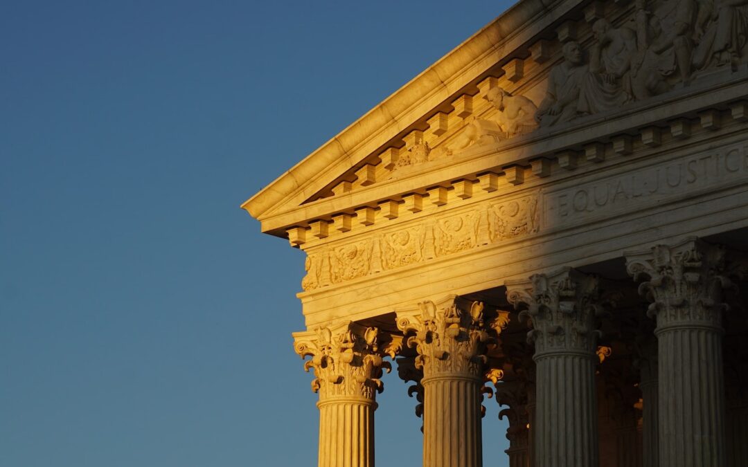 The exterior of the U.S. Supreme Court building with part of it in the shadows.