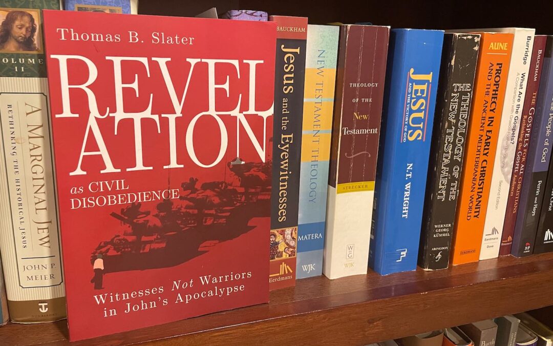 A book with a red cover on a shelf with several other books behind it.