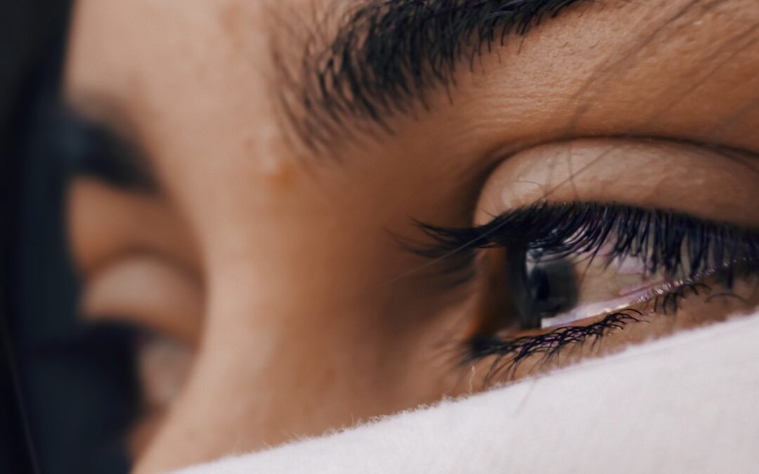 A close-up of a woman’s eyes that are filled with tears.