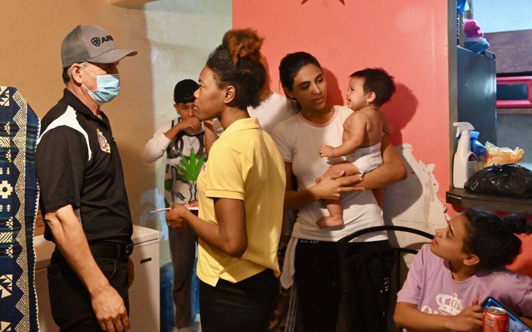A pastor offers comfort to migrants in a shelter in Nuevo Laredo, Mexico.