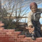 A mural of Harriet Tubman painted on a wall.