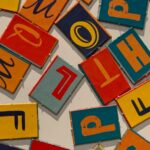 Colorful letters printed on cardboard sitting on a white table.