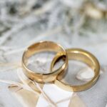 A pair of gold rings on top of white linen.
